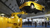 A Fanuc Corp. industrial robot moves a vehicle during a demonstration at the International Robot Exhibition 2015 in Tokyo, Japan, on Wednesday, Dec. 2, 2015. The expo runs through Dec. 5 under the motto "making a future with robots." Photographer: Tomohiro Ohsumi/Bloomberg