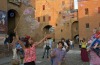 Children play in front of the 'Castello Estense', Ferrara.