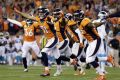 The Denver Broncos celebrate a missed game-winning field goal attempt by the Carolina Panthers during the second half of ...