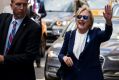 Democratic presidential candidate Hillary Clinton waves as she walks from her daughter's apartment building on September ...