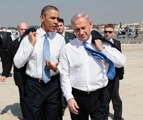 File - President Barack Obama walks across the tarmac with Israeli Prime Minister Benjamin Netanyahu at Ben Gurion International Airport in Tel Aviv, Israel, March 20, 2013.