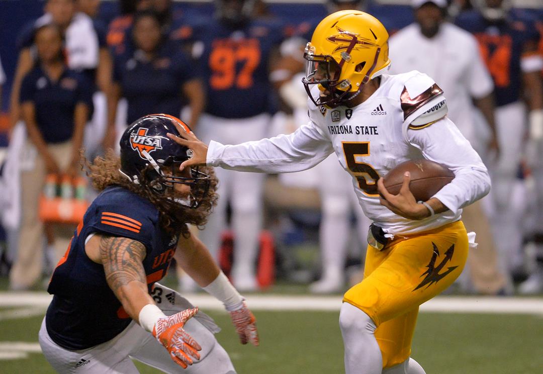 ASU QB Manny Wilkins stiff arms a UTSA defender during the Sun Devils' 32-28 victory (AP Photo/Darren Abate)