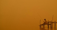 A boy went fishing in Palangkaraya, Indonesia, while the deadly haze blanketed the region last year. (Photo: Haris Sadikin/AFP/Getty Images)