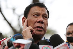 Philippine presidential candidate Rodrigo Duterte gestures as he answers questions from reporters at the University of the Philippines in suburban Quezon city, north of Manila, Philippines, Thursday, Feb. 18, 2016.