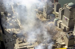 File - An aerial view, days after the terrorist attacks on American soil, the towers of the World Trade Center (WTC) sit as a pile of rubble in the streets of New York City.