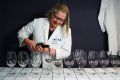 Wine steward Liz Watt sets up for the judging at the Canberra Wine Show. 