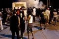 Police fire tear gas into the crowd of protesters on Old Concord Road, Charlotte, late on Tuesday night.