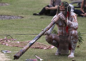 File - An Aboriginal man plays a didgeridoo during Australia Day in Sydney, Australia, Tuesday, Jan. 26, 2016.