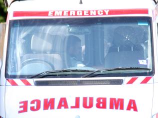 Siege in Garfield. Paramedics treat the man in the back of an ambulance before taking him away. Picture: Hamilton Fiona