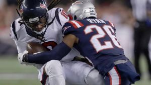 Doing damage: New England Patriots cornerback Logan Ryan tackles Houston Texans wide receiver DeAndre Hopkins.