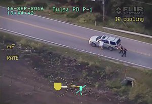 FILE - In this photo made from a Sept. 16, 2016 police video, Terence Crutcher, left, with his arms up is pursued by police officers as he walks next to his stalled SUV moments before he was shot and killed by one of the officers in Tulsa, Okla.