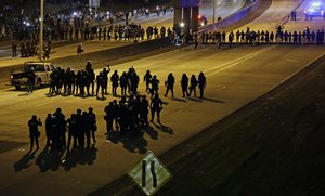 Police confront protesters blocking I-277 during demonstrations following Tuesday's police shooting of Keith Lamont Scott in Charlotte, N.C., Thursday, Sept. 22, 2016.