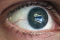 LONDON, ENGLAND - MARCH 25: In this photo illustration the Social networking site Facebook is reflected in the eye of a ...