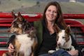 Lynn Davies at her home near Canberra with her dogs Smorgasbord (left) and PooNeck.