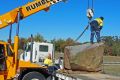 A giant Moruya granite rock with 'wow' factor is delivered to the National Rock Garden.