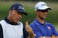 Adam Scott speaks with his caddie Steve Williams.