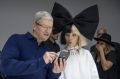 Tim Cook, chief executive officer of Apple, holds an iPhone 7s while speaking with dancer Maddie Ziegler.
