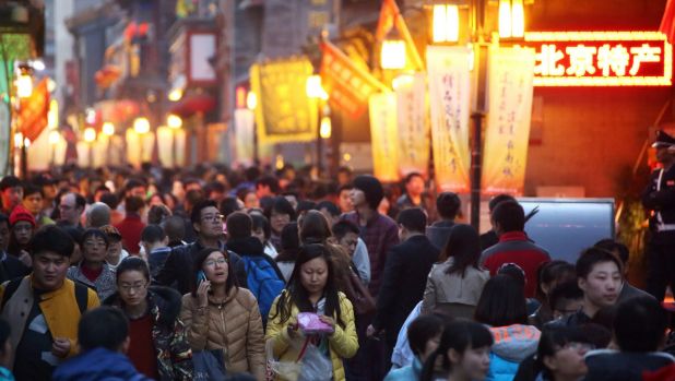 Shoppers walk along a shopping street in Beijing, China, where internet addiction is a big problem.