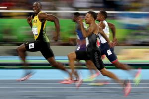 Smile for the camera: Usain Bolt competes in the men's 100m semi-final.