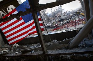 File - The American flag is a prominent icon in the heart of what was once the World Trade Center in New York City, Sept. 15, 2001.