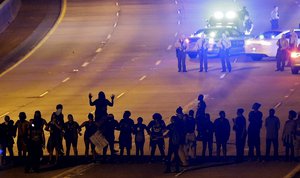 Protesters block I-277 during a third night of unrest following Tuesday's police shooting of Keith Lamont Scott in Charlotte, N.C., Thursday, Sept. 22, 2016.