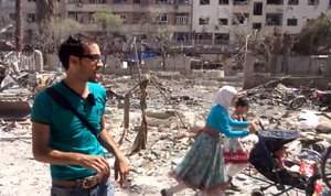 This image made from video posted online by the Shaam News Network, a loosely organized group opposed to Bashar Assad, on Sunday, Aug. 16, 2015, which has been verified and is consistent with other AP reporting, shows the aftermath of Syrian government airstrikes in Douma, a suburb of Damascus, Syria.