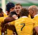 PERTH, AUSTRALIA - SEPTEMBER 17: Will Genia of Australia is congratulated by team mates after crossing for a try during ...