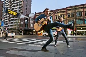 Dan Mac and Jim Finn of Art vs Science play near the shuttered Exchange Hotel on Oxford Street to protest against ...