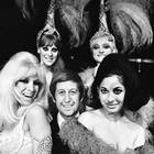 21st July 1967: Club owner Paul Raymond and four of his revue dancers, who are on their way to Aden to entertain the troops. The dancers are Carole Ryva, Jean Crabtree, Lady Flan and Sandra Bunting. (Photo by C. Maher/Express/Getty Images)