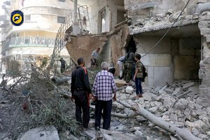 In this photo provided by the Syrian Civil Defense White Helmets, rescue workers work the site of airstrikes in al-Mashhad neighborhood in the rebel-held part of eastern Aleppo, Wednesday Sept. 21, 2016.