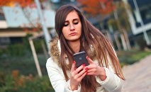 A young girl using her smartphone.