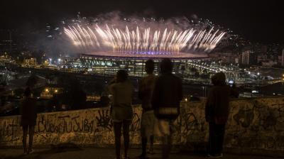 The curtains came down on the 2016 Rio Olympic Games on Sunday. This picture, people of the Mangueira slum watch the Olympics closing ceremony at the Maracana stadium in the distance.