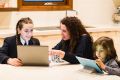 Cathy Filardo is seen helping her children, 13-year-old Siena and 5-year-old Massimo with their homework at home in ...