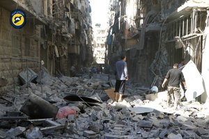 In this photo provided by the Syrian Civil Defense group known as the White Helmets, Syrians inspect damaged buildings after airstrikes hit in Aleppo, Syria, Saturday, Sept. 24, 2016.