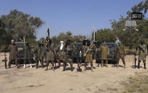 In his file image taken from video released late Friday evening, Oct. 31, 2014, by Boko Haram, Abubakar Shekau, centre, the leader of Nigeria's Islamic extremist group is seen.