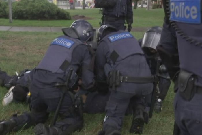 Police arrest a man at Coburg rally