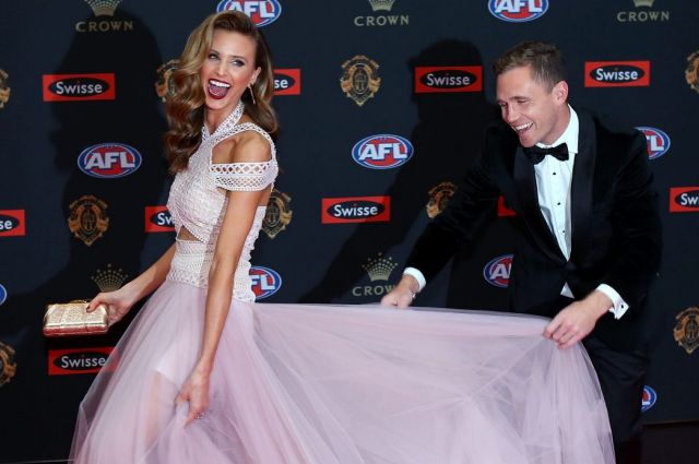 Joel Selwood of the Geelong Cats and Brit Davis do their thing on the Brownlow red carpet.