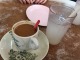 Drinks and toast at a snall coffee shop. On the right - barley tea. On the left - 'Cham', which is a mixture of coffee and a sweet tea.