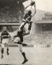 Footscray rover Merv Hobbs flies over Melbourne's Trevor Johnson to mark in the VFL 1961 preliminary final at the MCG. 