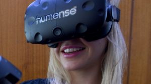 Co-founder Amber Cordeaux using Humense's human-to-human virtual reality headset.