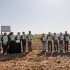 Palestinian and international activists hold signs in support of the Boycott, Divestment and Sanctions (BDS) movement by the buffer zone in Zeitoun on 9 February 2013.