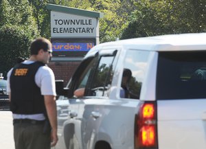 Members of law enforcement talk in front of Townville Elementary School on Wednesday, Sept. 28, 2016, in Townville, S.C.