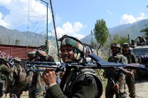 File - Indian army soldiers walk back after a gun battle at Aragam, about 72 kilometers north of Srinagar, Indian controlled Kashmir, Thursday, Sept. 22, 2016.