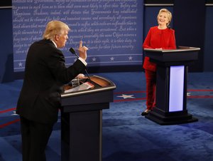 Democratic presidential nominee Hillary Clinton smiles as Republican presidential nominee Donald Trump speaks during the presidential debate at Hofstra University in Hempstead, N.Y., Monday, Sept. 26, 2016.