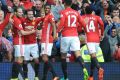 Manchester United's Juan Mata celebrates with team mates after scoring.