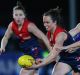 The Demons' Daisy Pearce runs with the ball during the AFL Women's exhibition match against the Western Bulldogs earlier ...