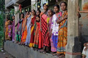 Villagers wait on a verandah to witness the funeral procession of Indian army soldier Gangadhar Dalai, who was killed in ...