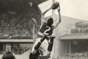 Footscray rover Merv Hobbs flies over Melbourne's Trevor Johnson to mark in the VFL 1961 preliminary final at the MCG. 