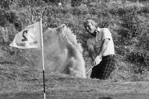 July 1976: Arnold Palmer hits a shot from the bunker onto the green during a match at the Royal Birkdale, Lancashire.