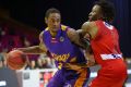 Making a splash: Kings import Greg Whittington is guarded by Perth's Jaron Johnson during the Australian Basketball ...